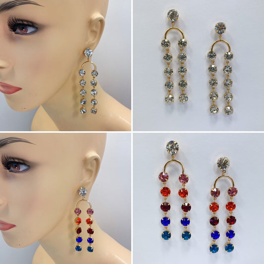 A collection of rhinestone tassel fringe earrings in various colors displayed on a mannequin ear.
