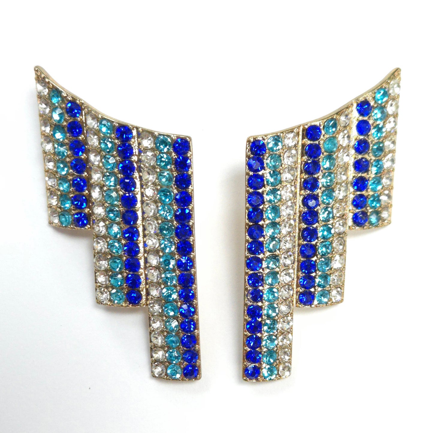 Pair of earrings with blue and clear gemstones on a white background