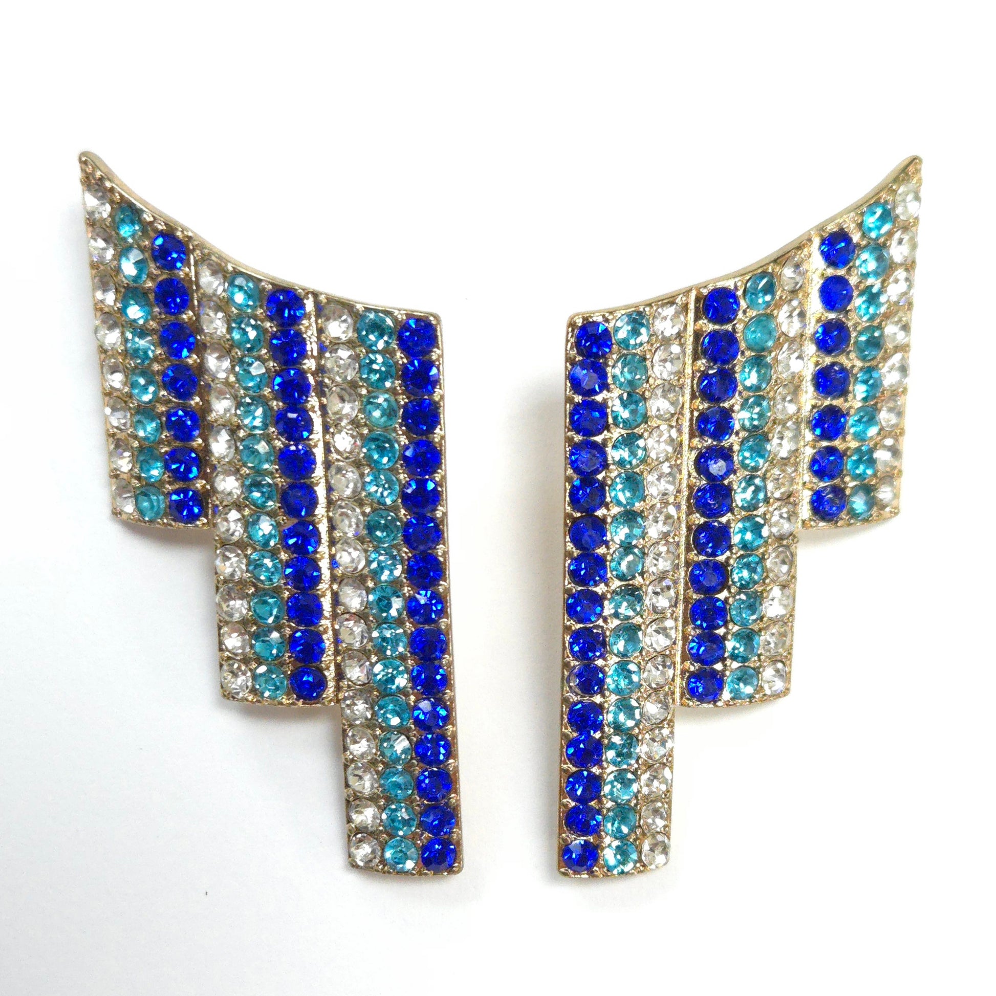 Pair of earrings with blue and clear gemstones on a white background
