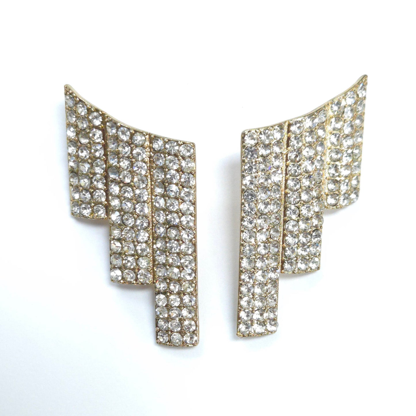 Pair of gold and crystal earrings on a white background