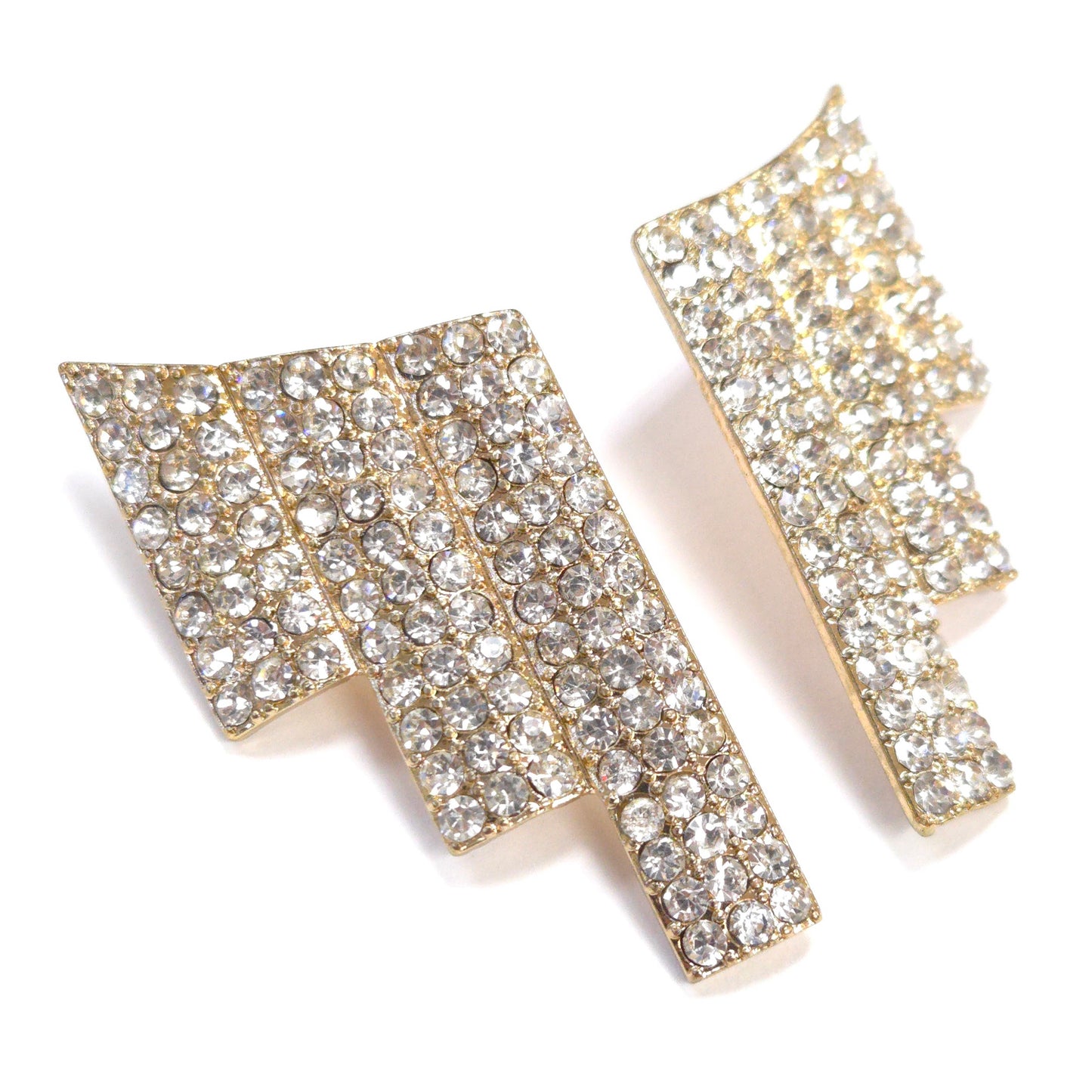 Gold and crystal earrings on a white background