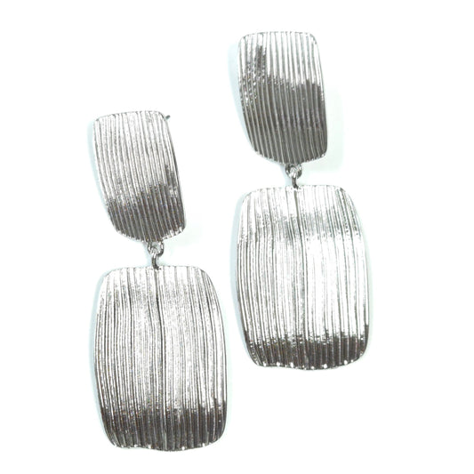 Pair of silver textured earrings on a white background