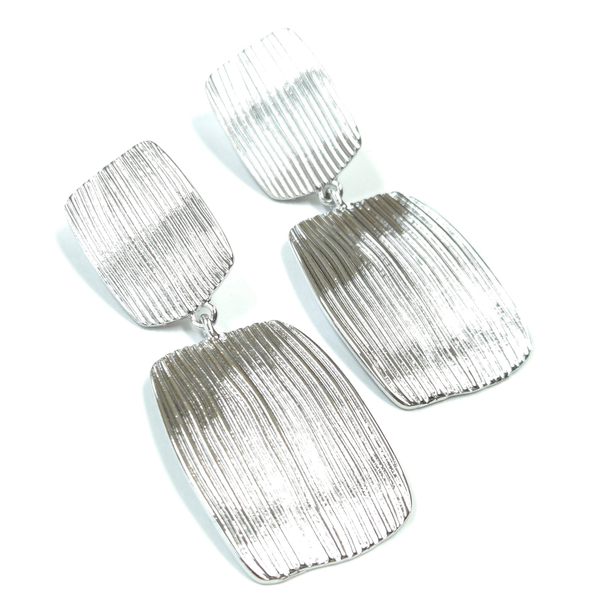Silver textured earrings on a white background
