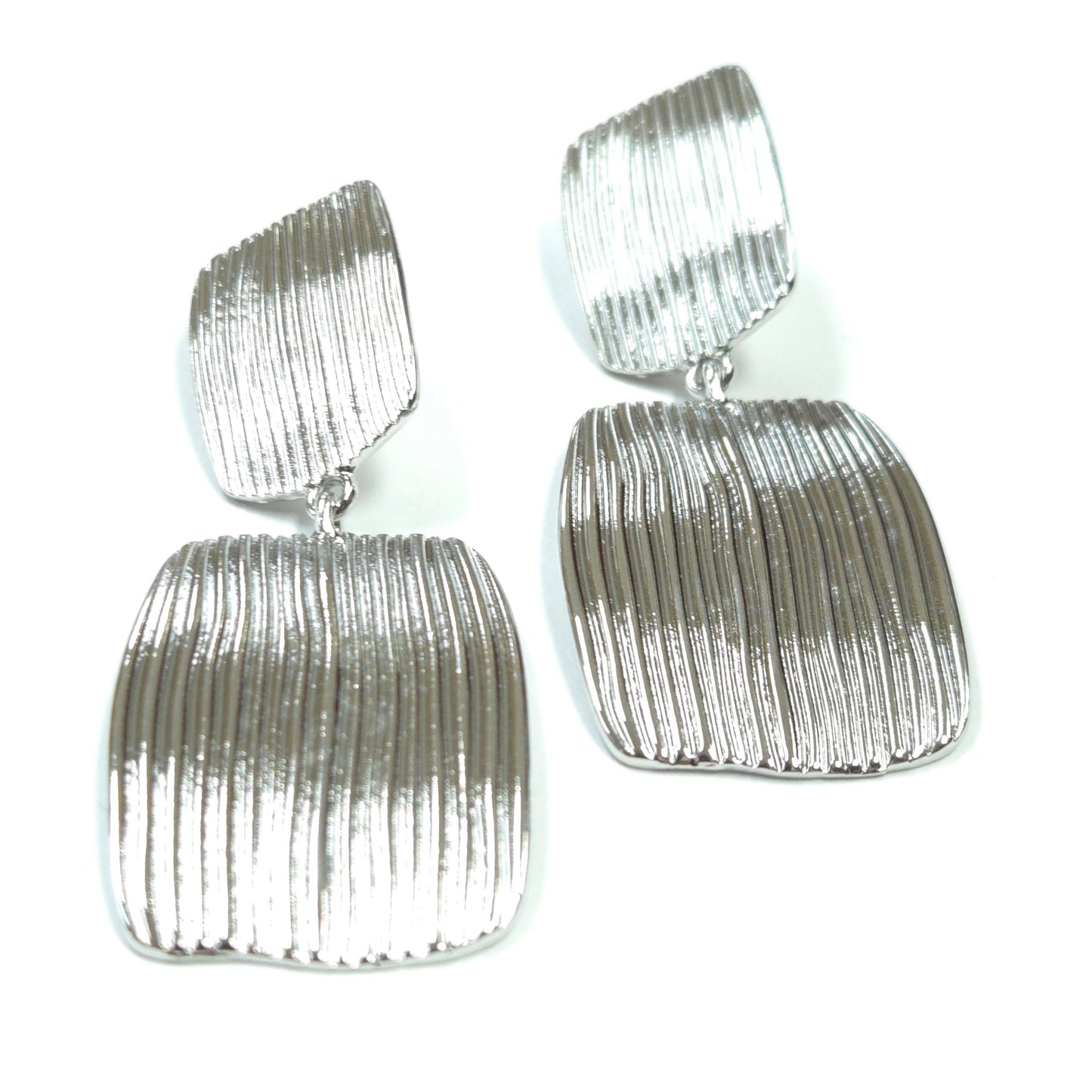 Pair of silver textured earrings on a white background