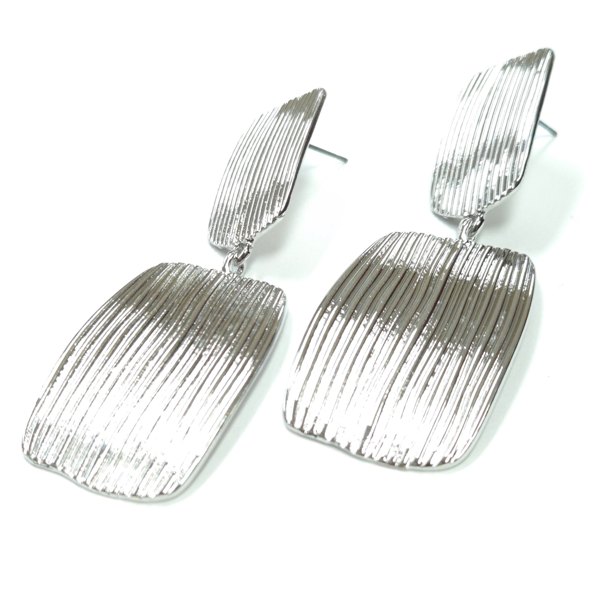 Pair of silver textured earrings on a white background