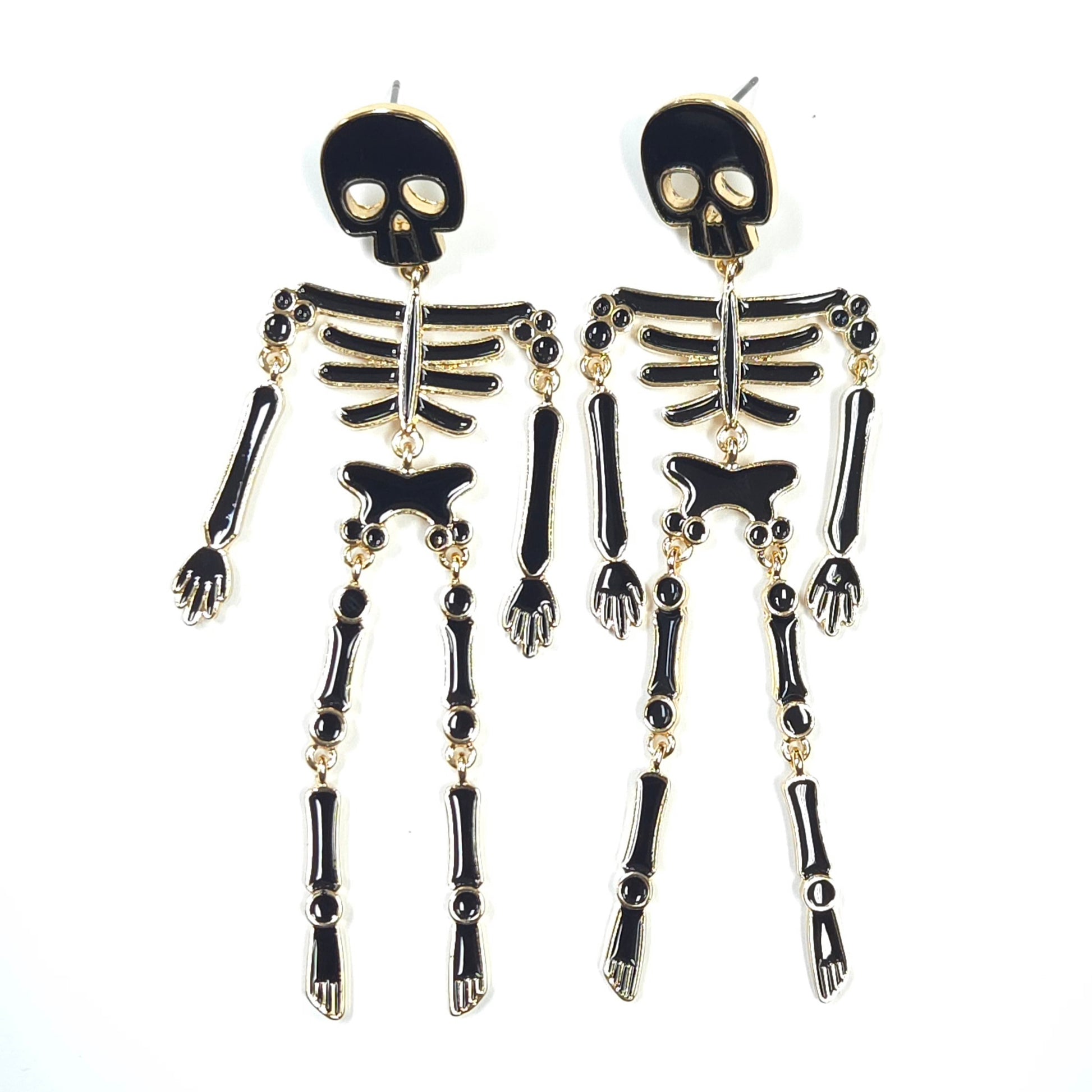 Skeleton design earrings on a white background