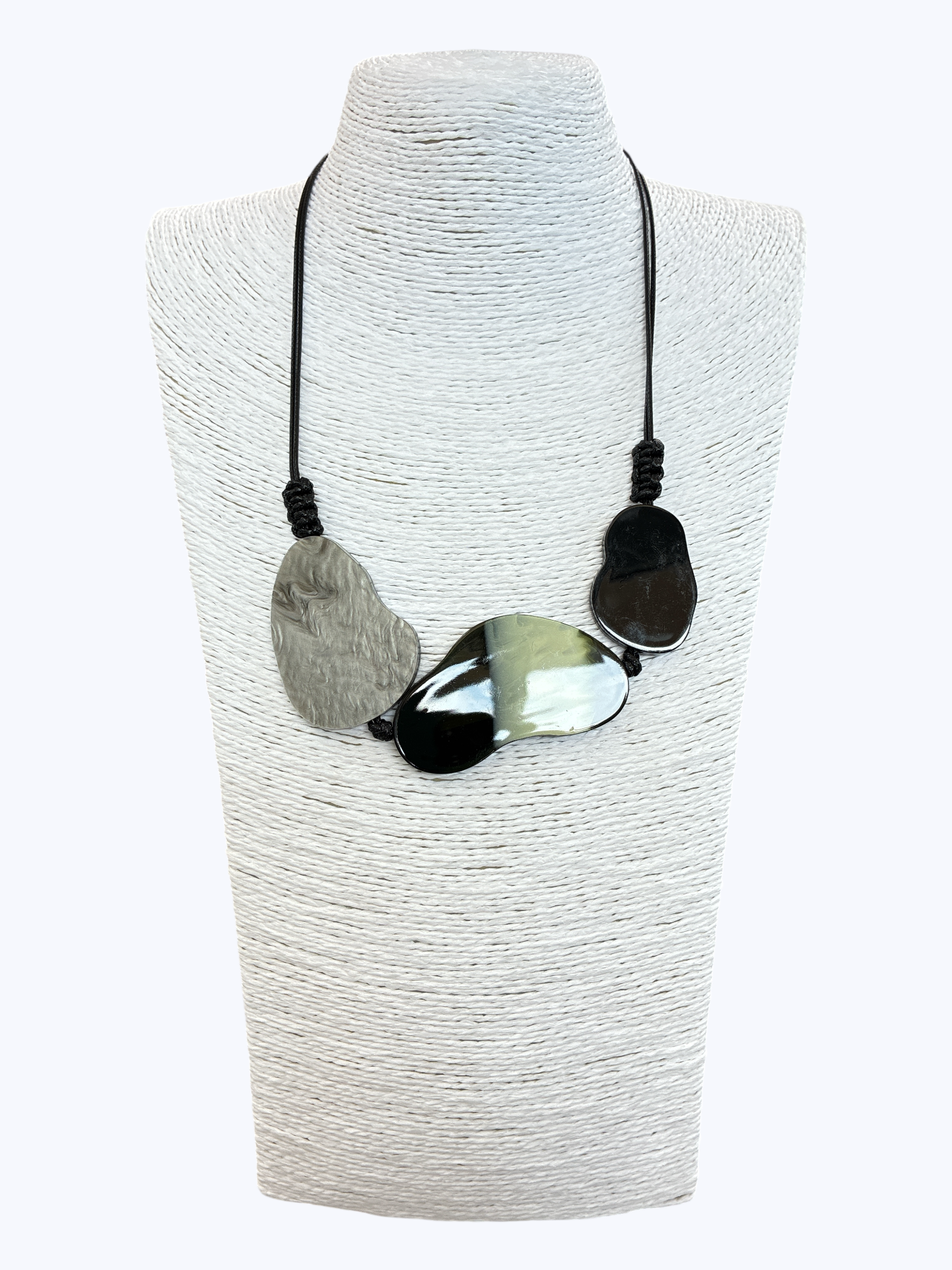 Abstract statement necklace with marbled black, gray, and white resin accents on black cord for a modern artistic boutique look.