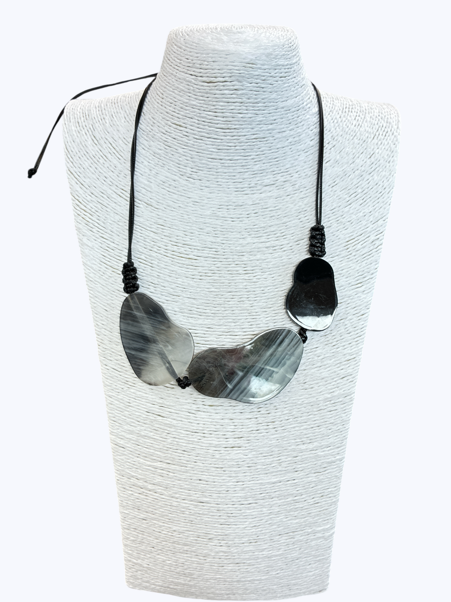 Abstract statement necklace with smoky gray marbled resin accents on black cord for a sleek modern boutique-inspired look.