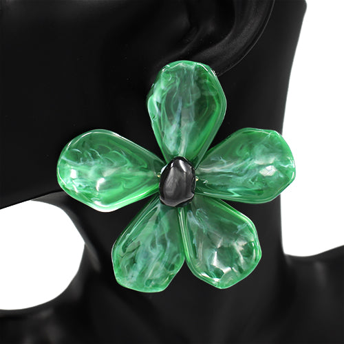 Green flower-shaped brooch on a black mannequin
