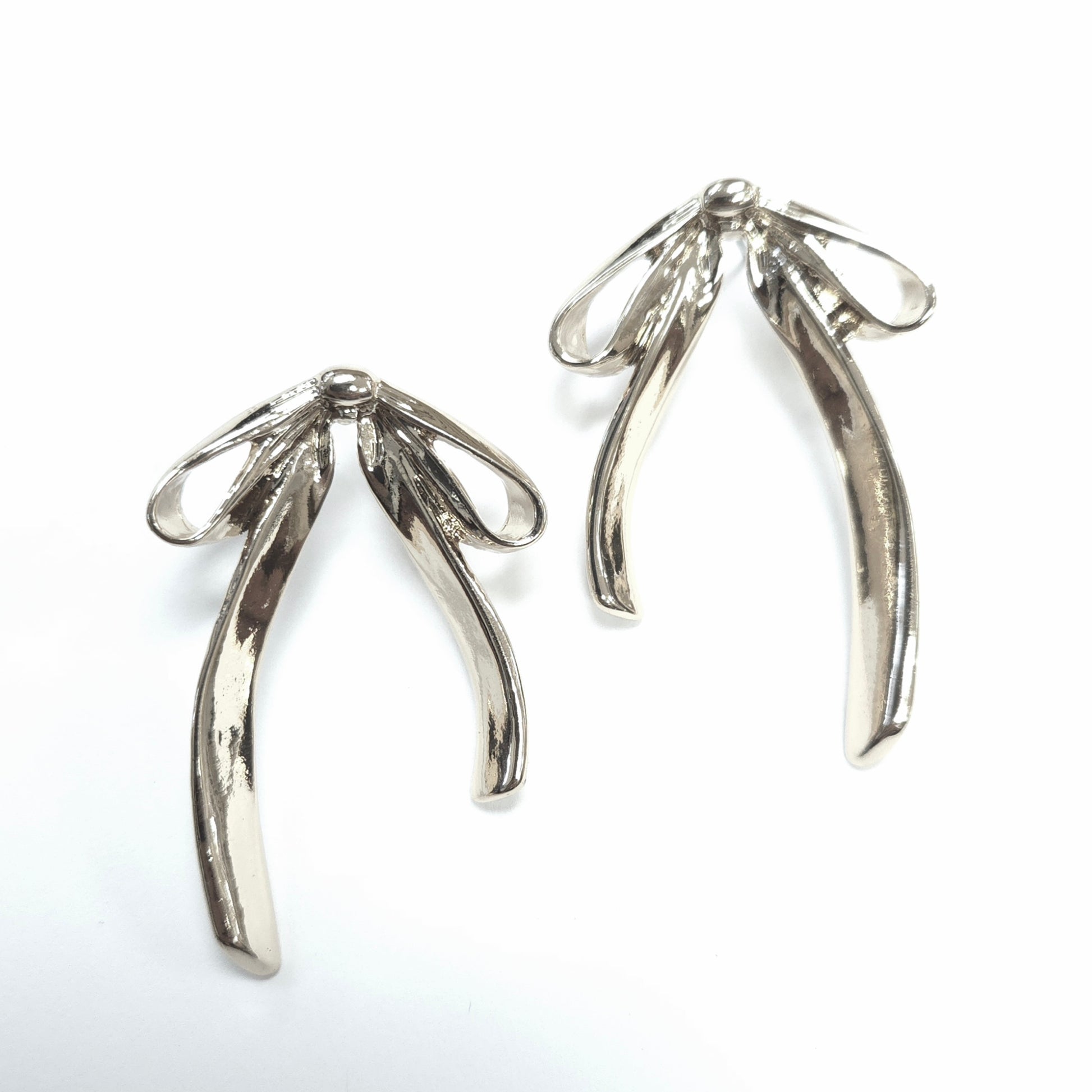Silver wishbone-shaped earrings on a white background