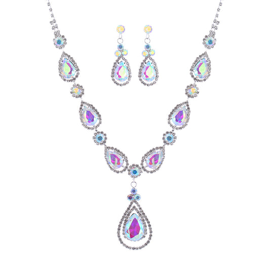 Jewelry set with necklace and earrings featuring teardrop-shaped gemstones on a white background