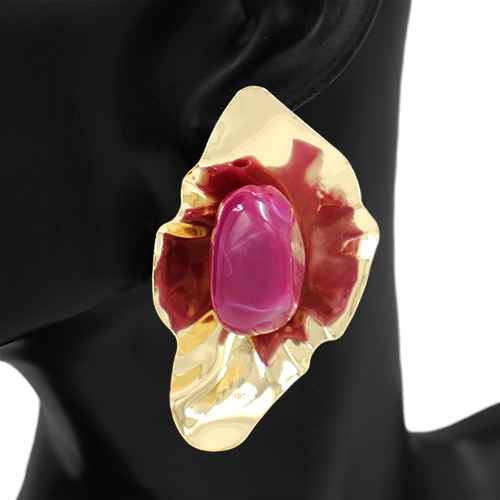 Gold ring with a pink gemstone on a black background