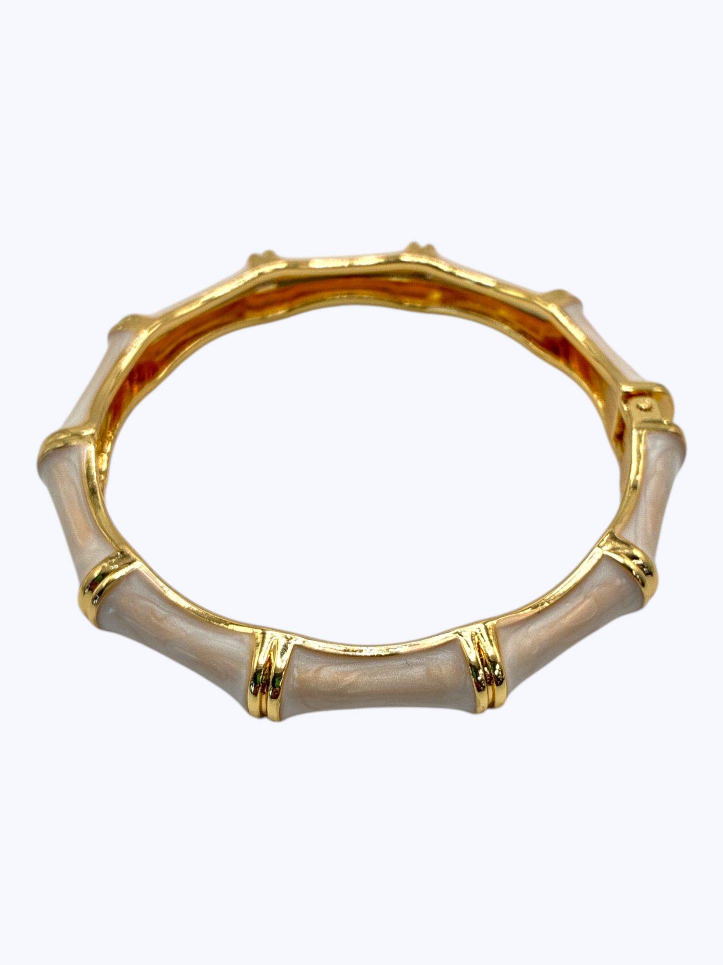 Gold and beige bangle on a white background