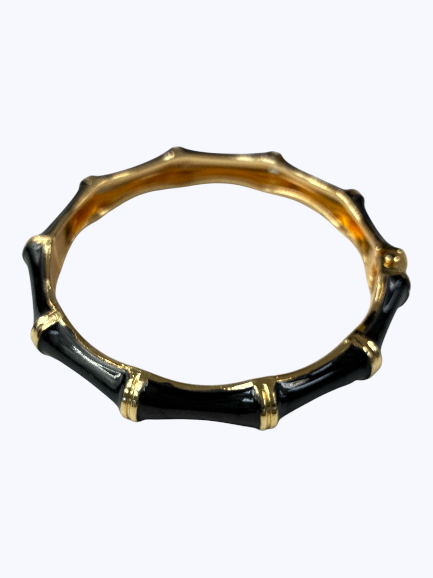 Black and gold bracelet on a white background
