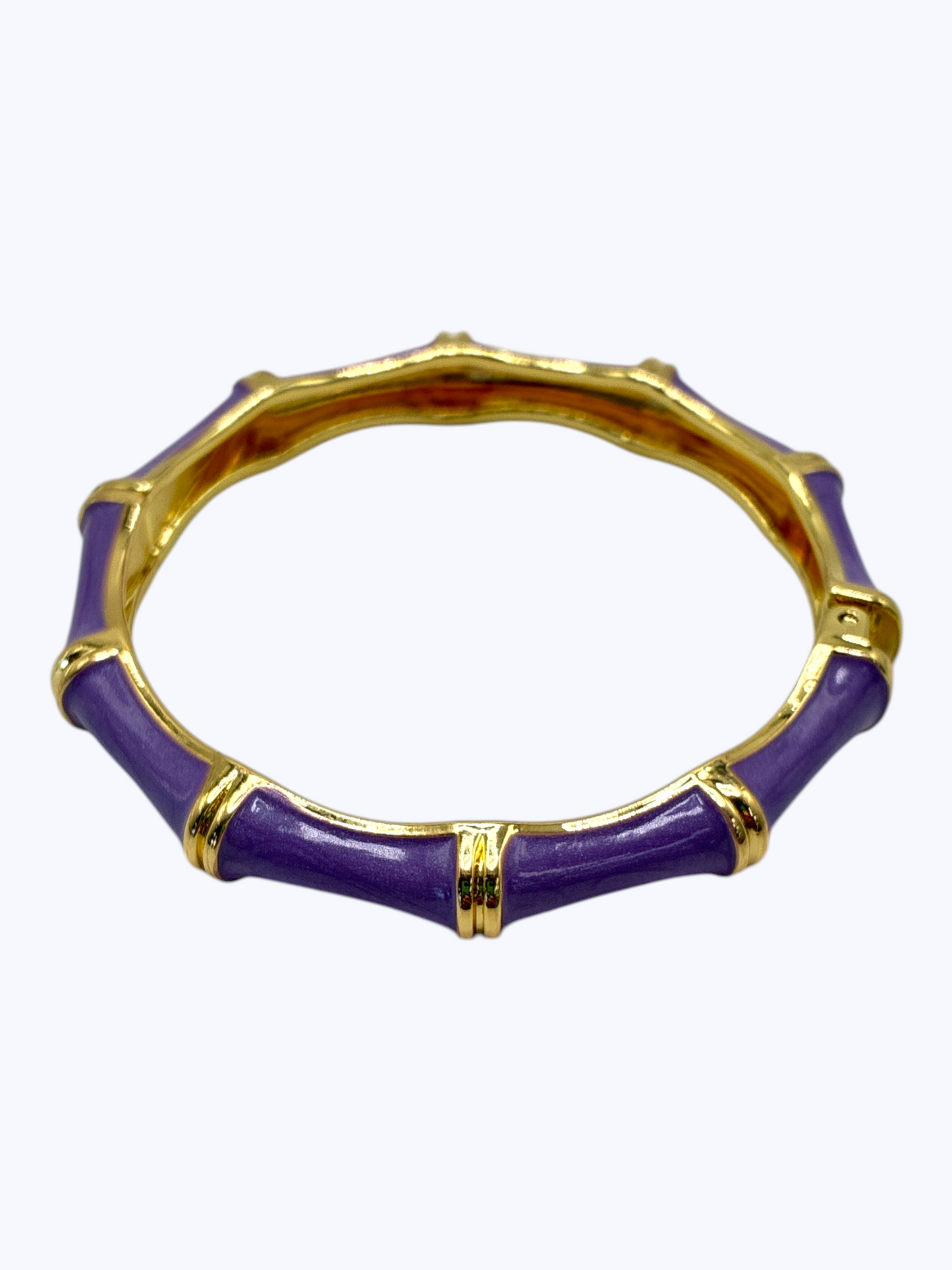 Purple bangle with gold accents on a white background