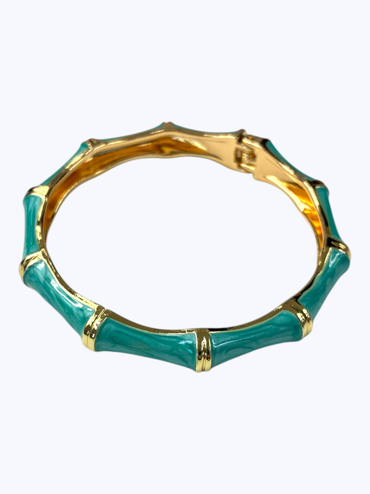 Teal bangle with gold accents on a white background