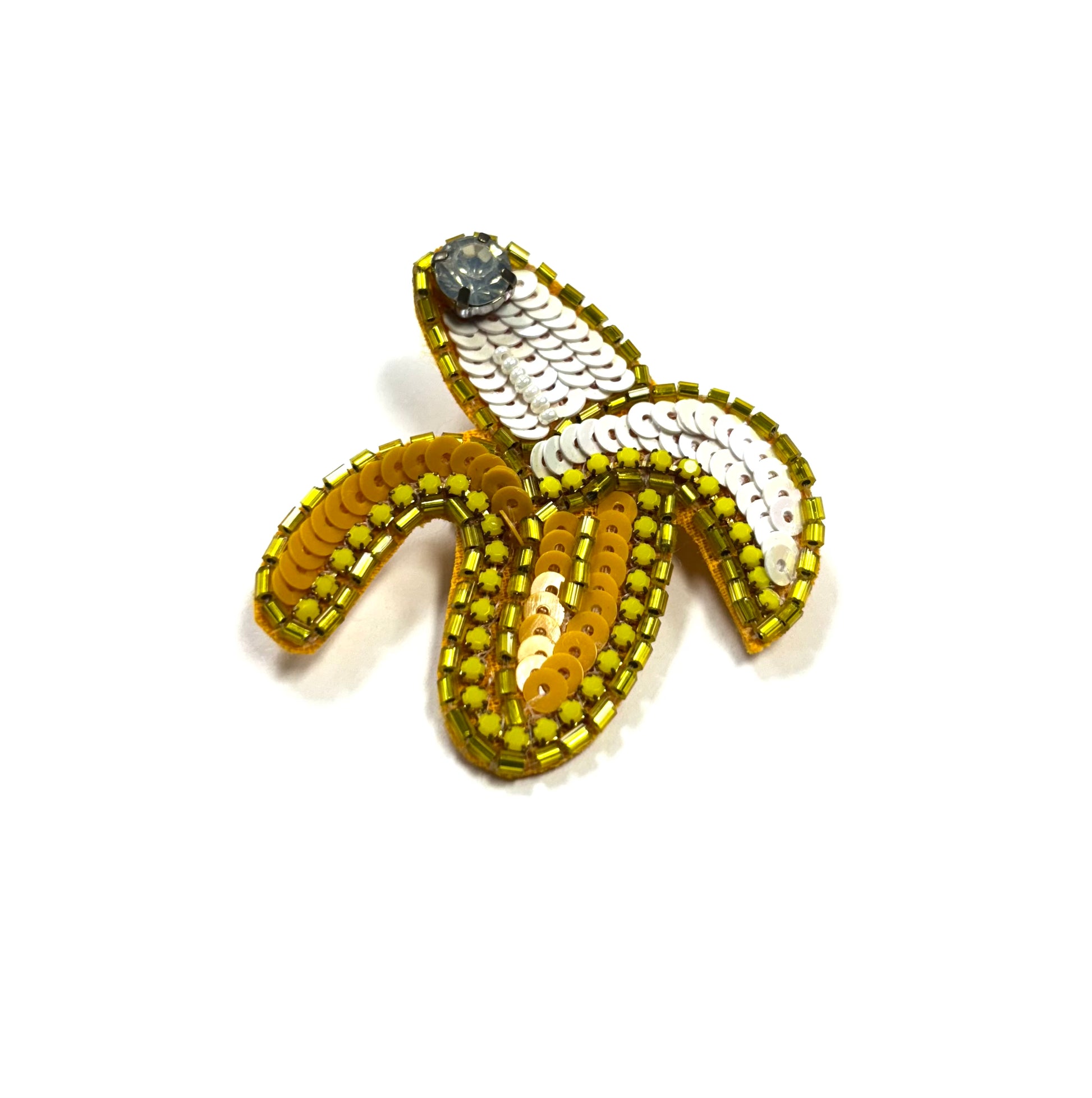 Beaded banana-shaped brooch on a white background
