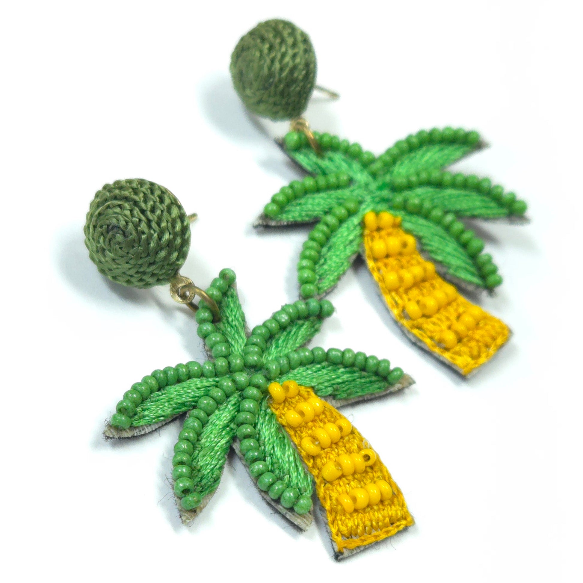 Pineapple-shaped earrings with green leaves and yellow bodies on a white background