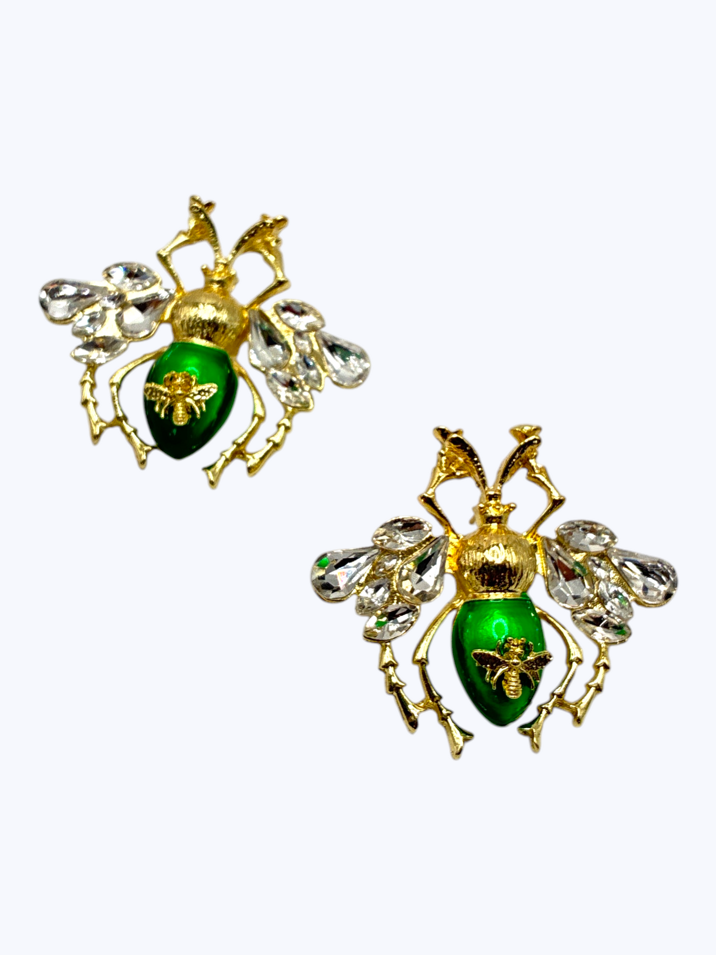 Gold bee statement earrings with crystal wing accents and glossy emerald enamel details for a bold luxe boutique look.