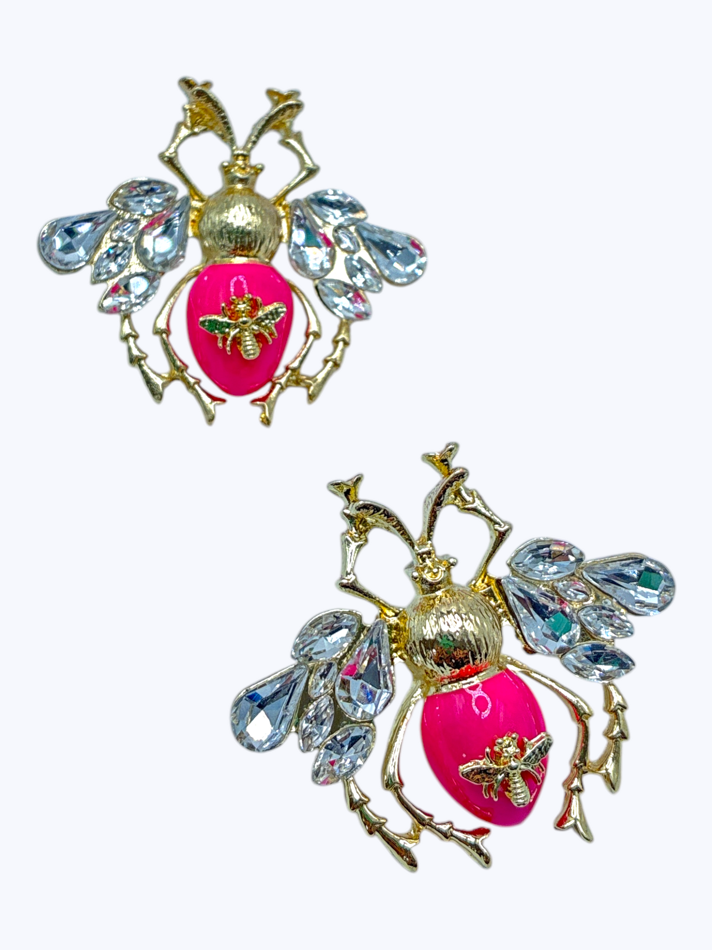 Gold bee statement earrings with crystal wing accents and vibrant pink enamel details for a fun glam boutique style.