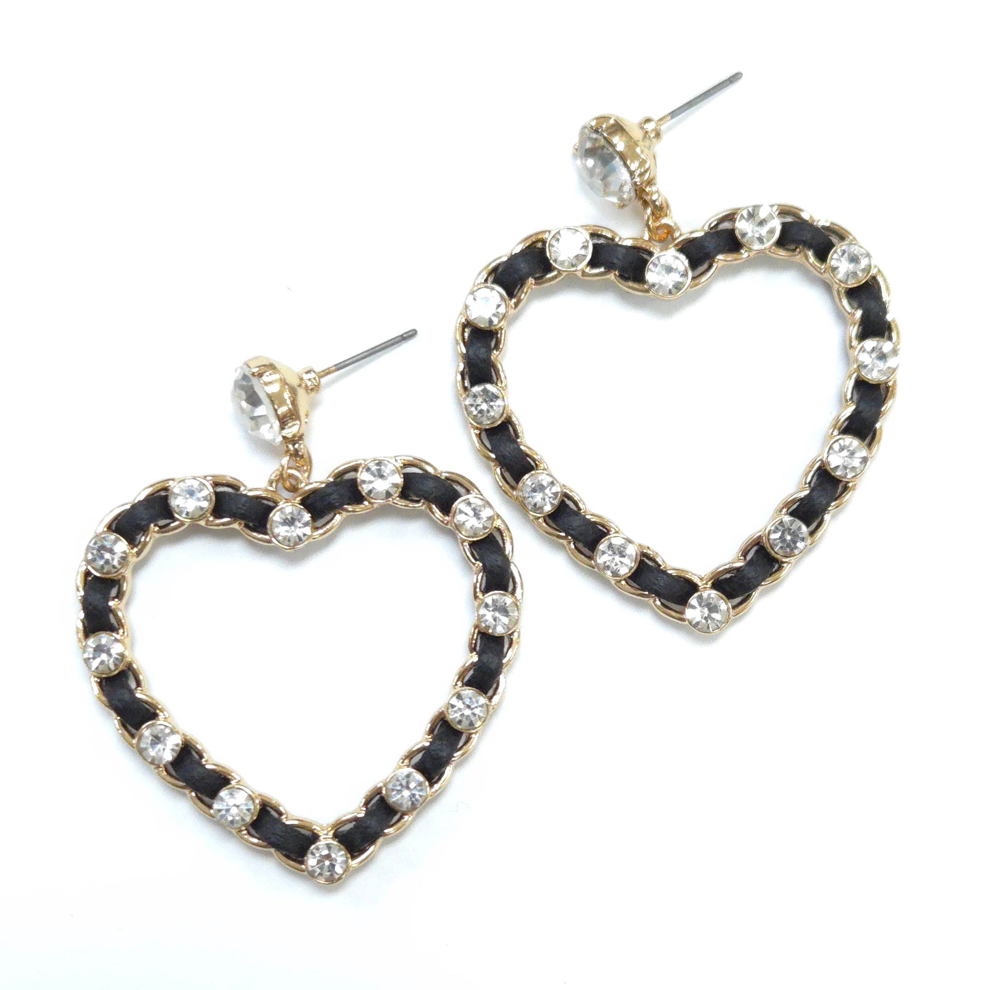 Heart-shaped earrings with black and gold design on a white background