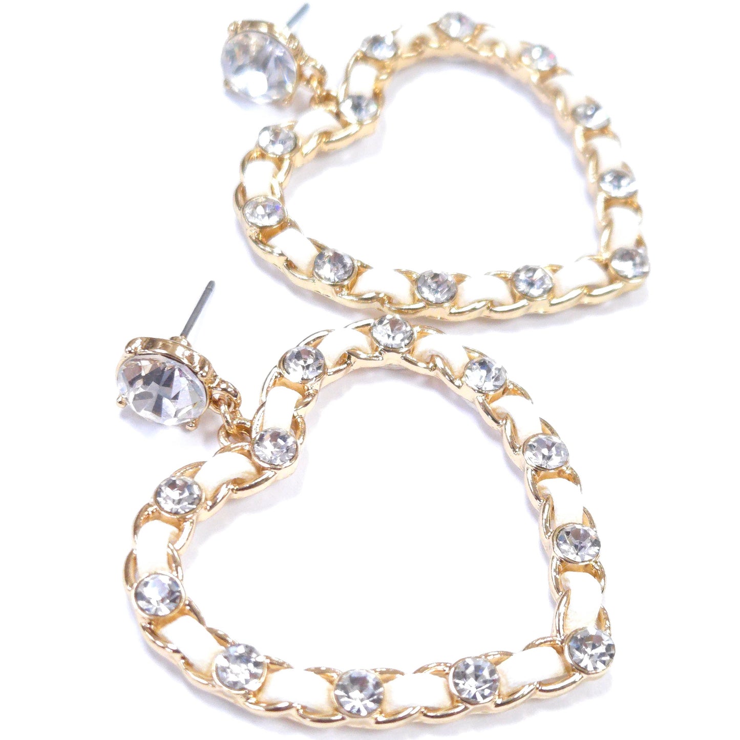 Heart-shaped earrings with gold frame and clear gemstones on a white background