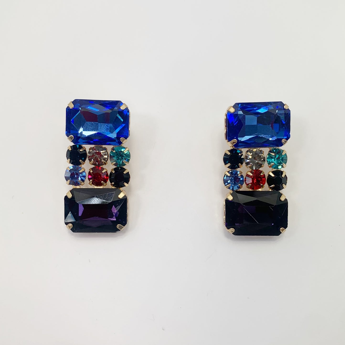 Rectangular crystal drop earrings with multicolor gemstone-inspired accents in a bold glamorous boutique style.