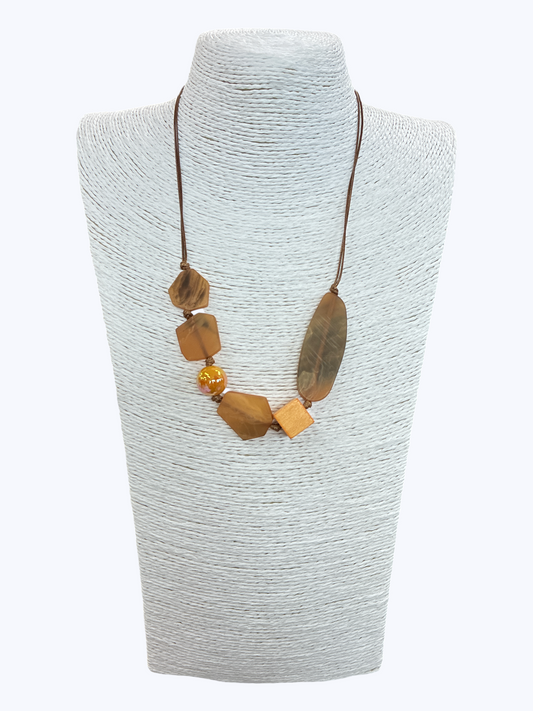 Earth-tone geometric bead necklace with marbled resin accents, wooden details, and asymmetrical styling for a natural boutique-inspired statement look.