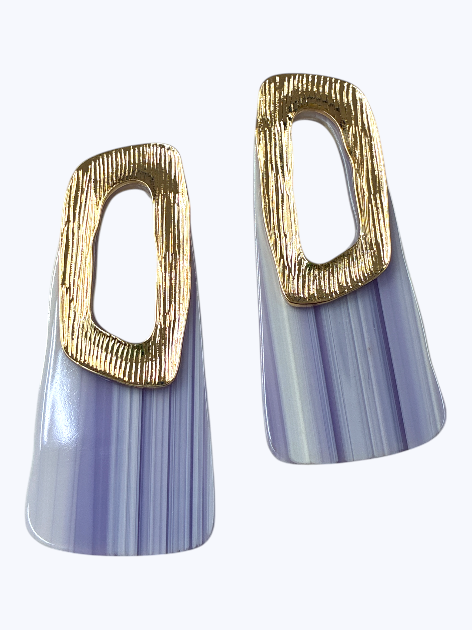 Modern geometric drop earrings featuring ribbed resin panel design with abstract metallic open-frame accent.