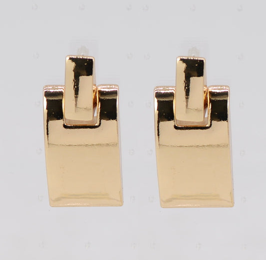 Pair of gold square earrings on a light gray background