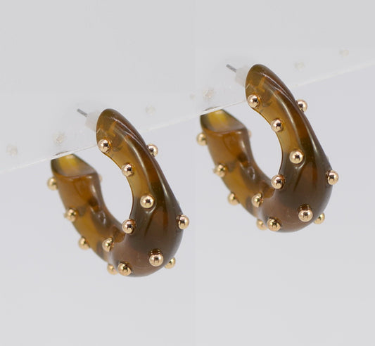 Hoop earrings with brown tortoiseshell design and gold accents on a light gray background