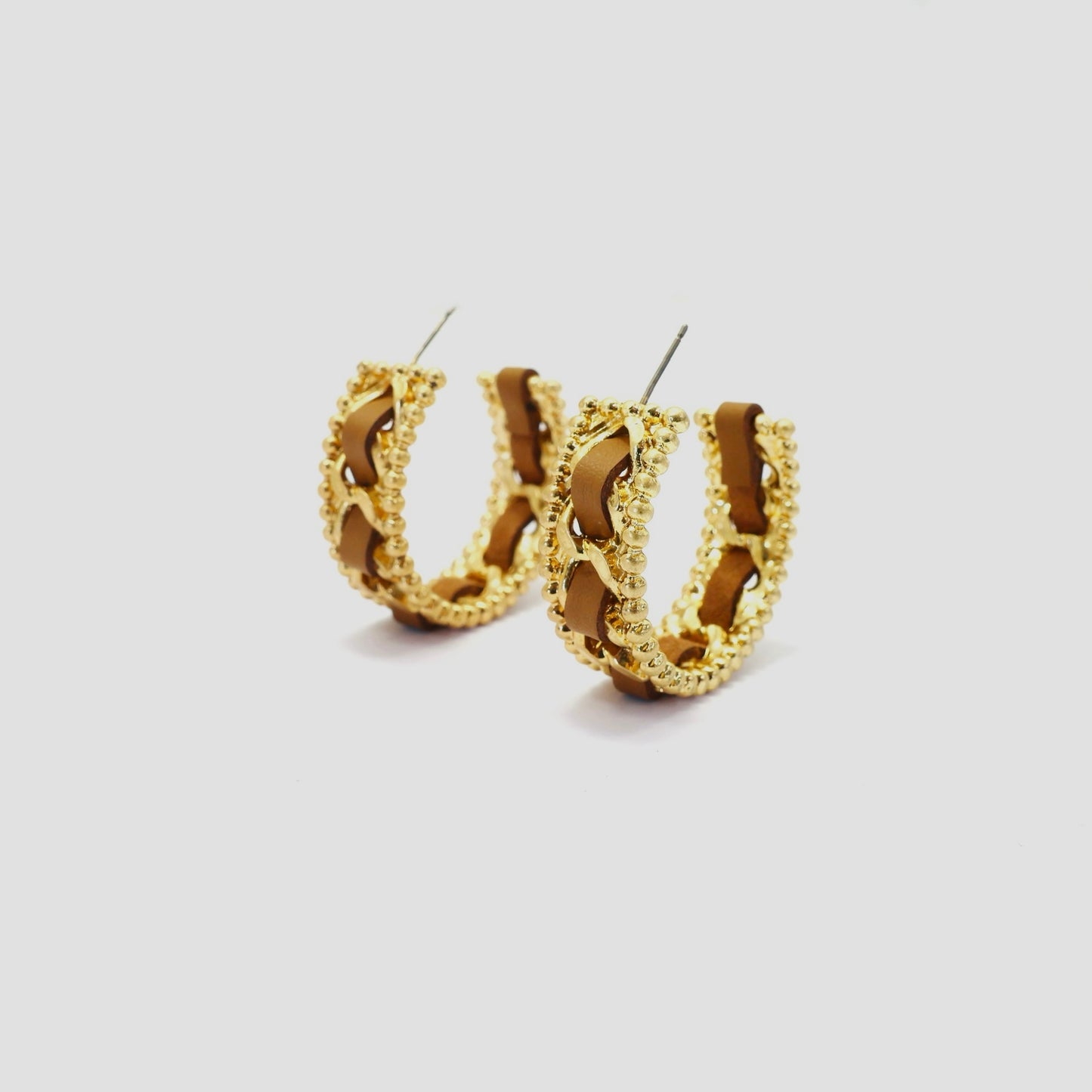 Braided chain hoop earrings with textured beaded edging and woven detail in a modern boutique fashion style.