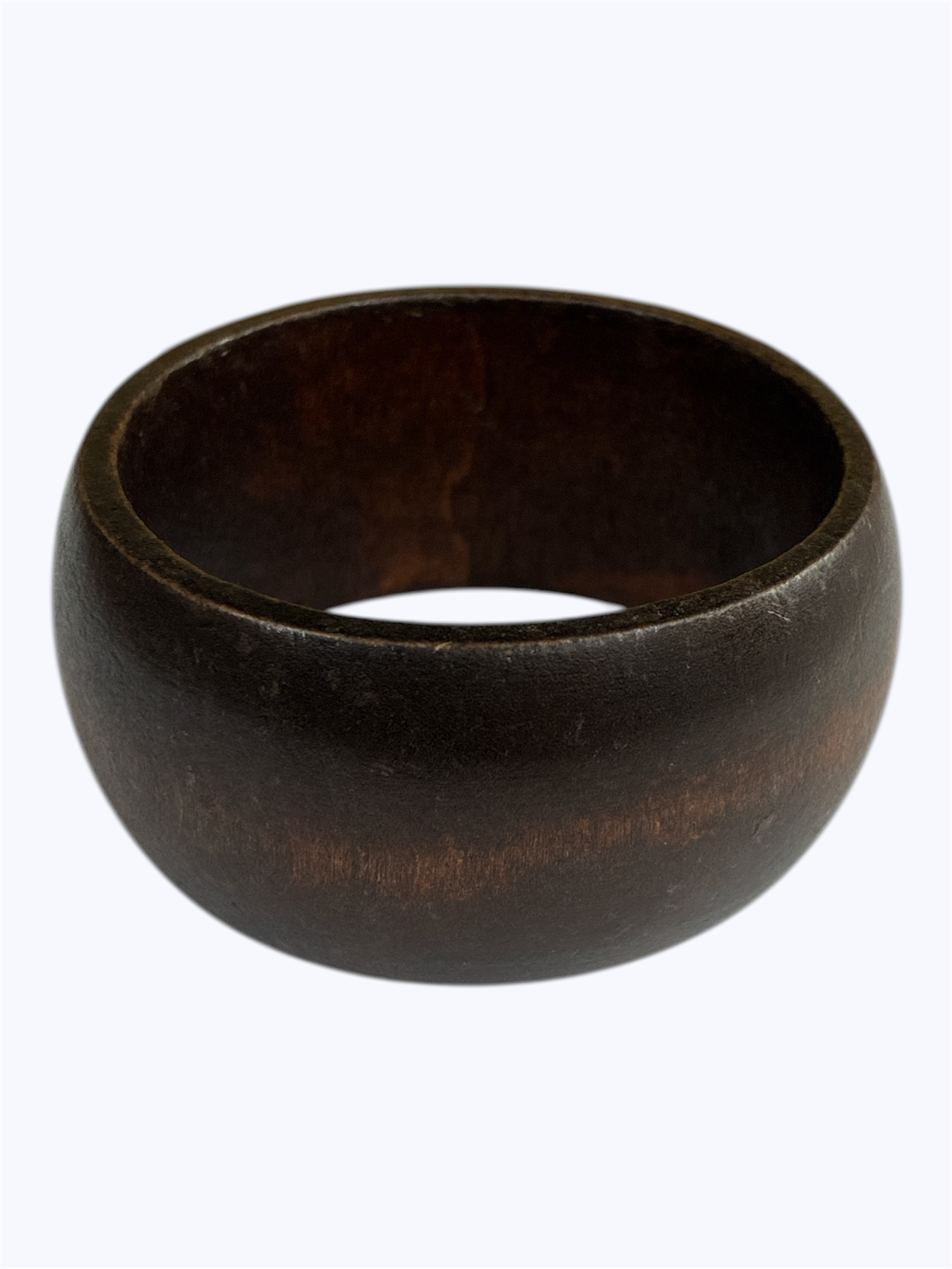 Dark wood bangle bracelet with a smooth rounded silhouette and minimalist artisan style