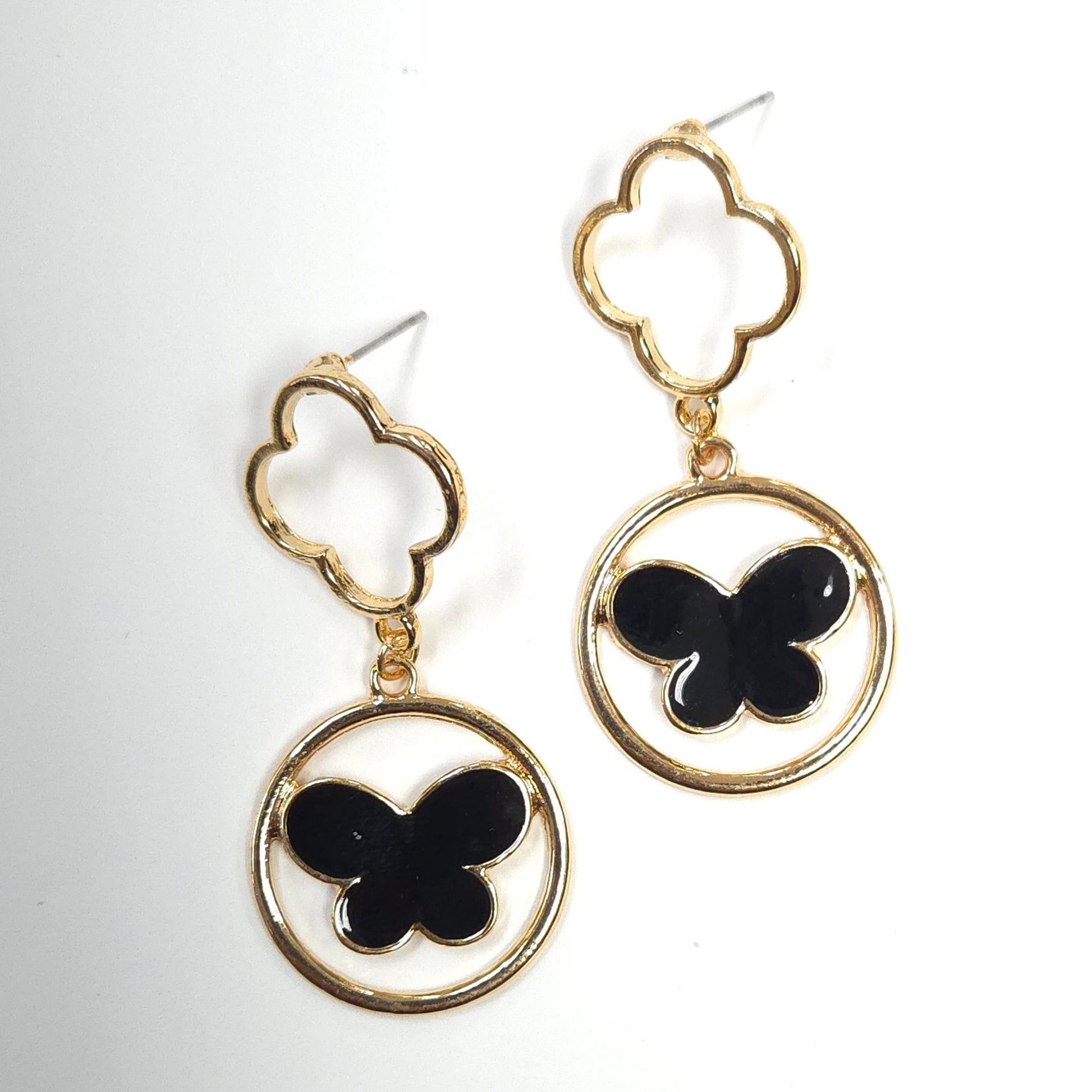 Gold earrings with black butterfly designs on a white background