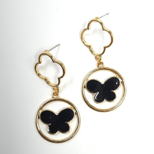 Gold earrings with black butterfly designs on a white background