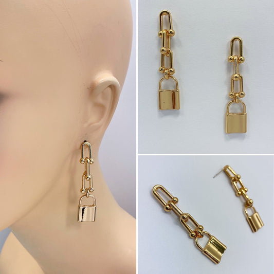 A pair of gold-colored lock-shaped dangle post earrings displayed from multiple angles, showing the front and back, as well as the earrings on a mannequin ear.