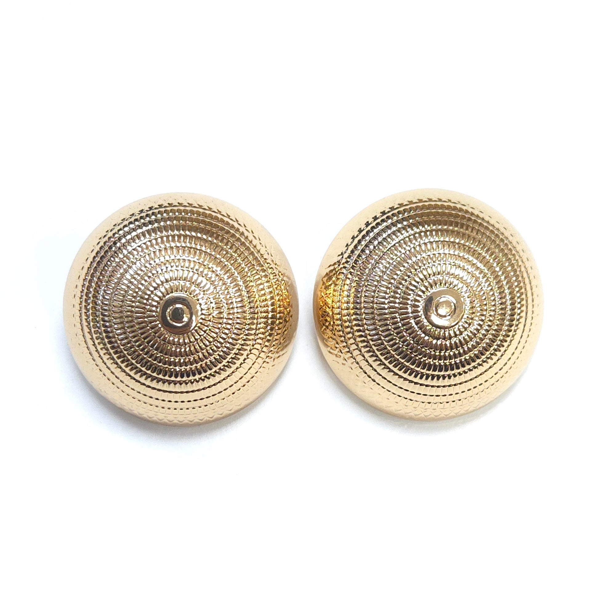 Pair of gold circular earrings on a white background