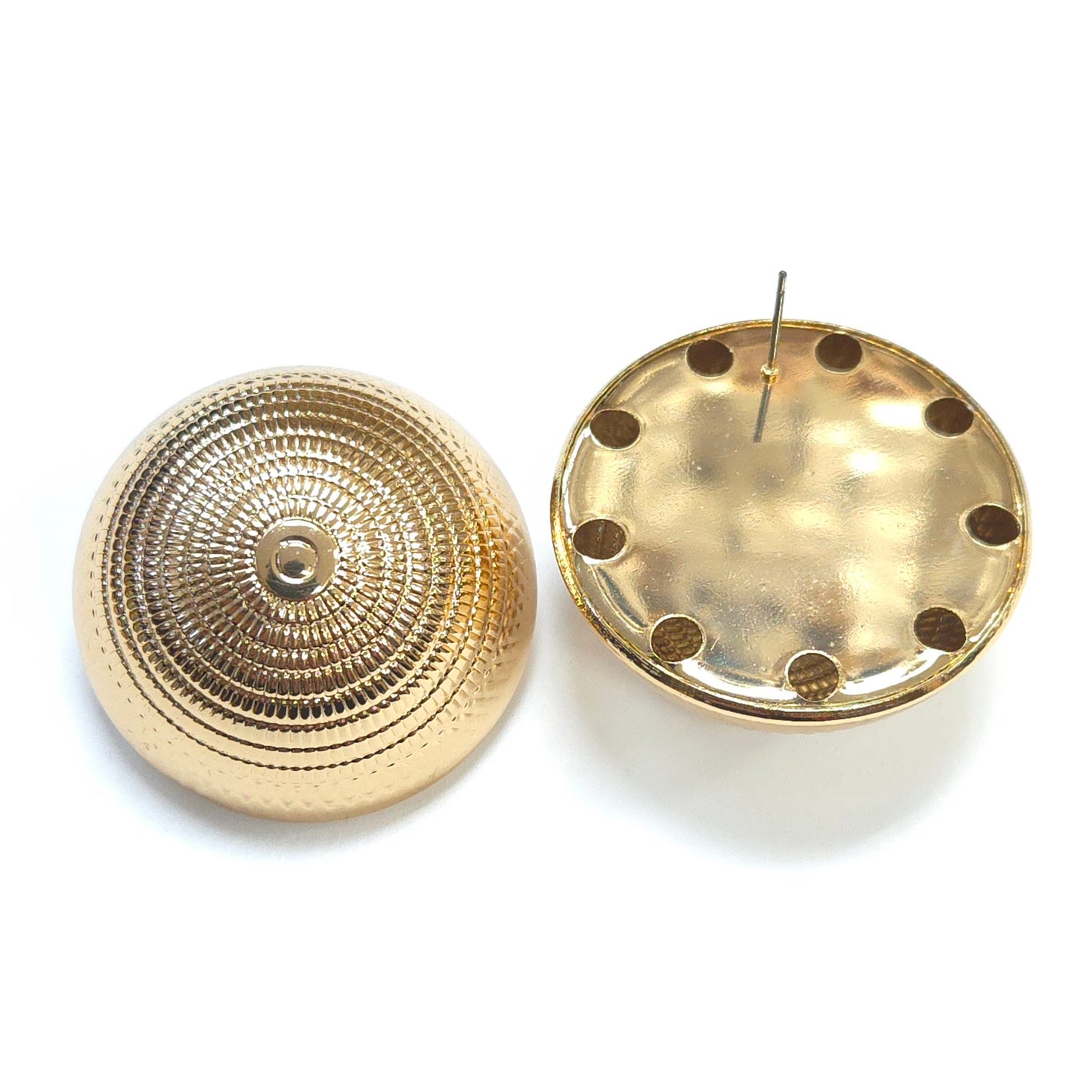 Two gold circular earring backs on a white background
