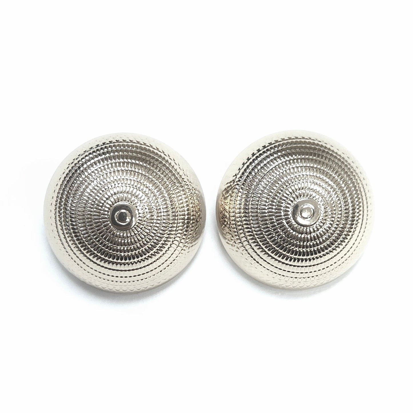 Pair of silver earrings with textured design on a white background