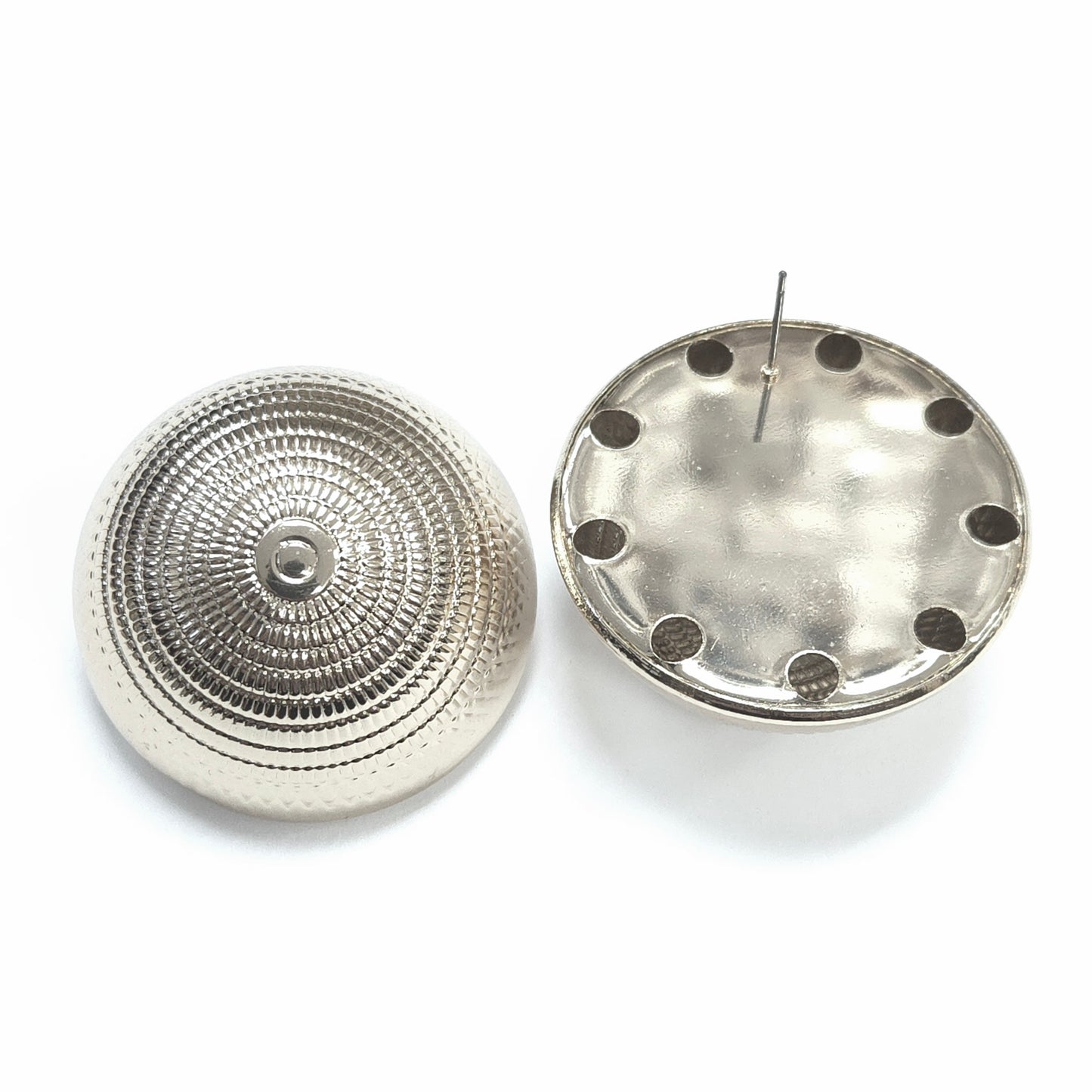 Two metallic circular components on a white background