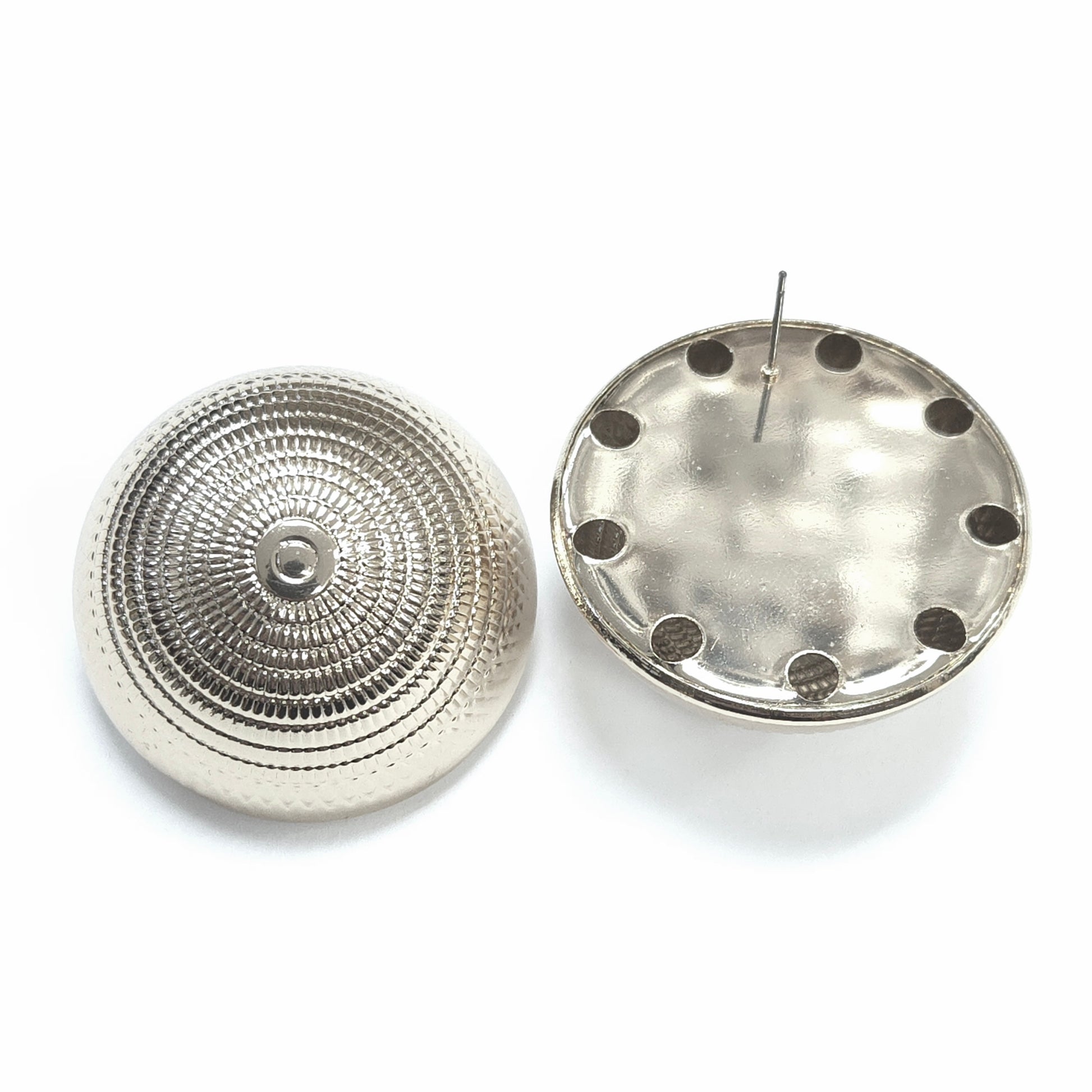 Two metallic circular components on a white background