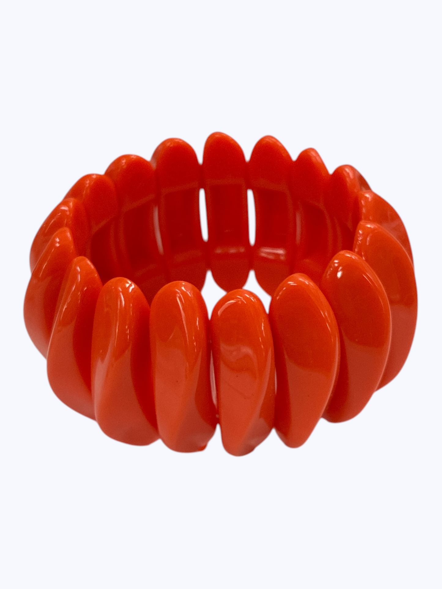 Chunky orange stretch bracelet with glossy oversized resin links for a bold playful boutique-inspired statement style.