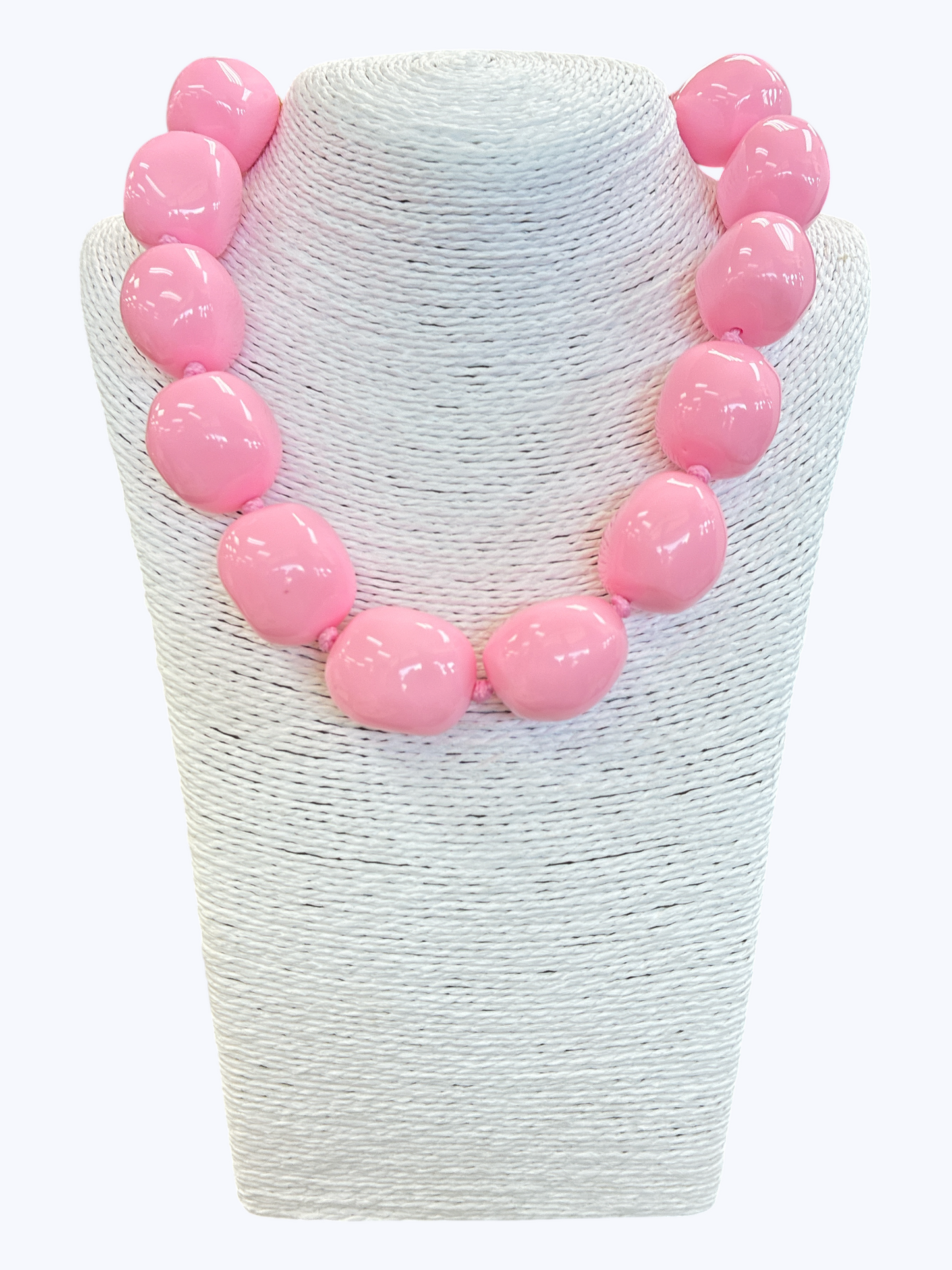 Chunky light pink statement necklace with oversized glossy resin beads for a soft feminine boutique look.