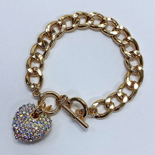 Gold chain bracelet with a heart-shaped charm featuring rhinestones on a light gray background