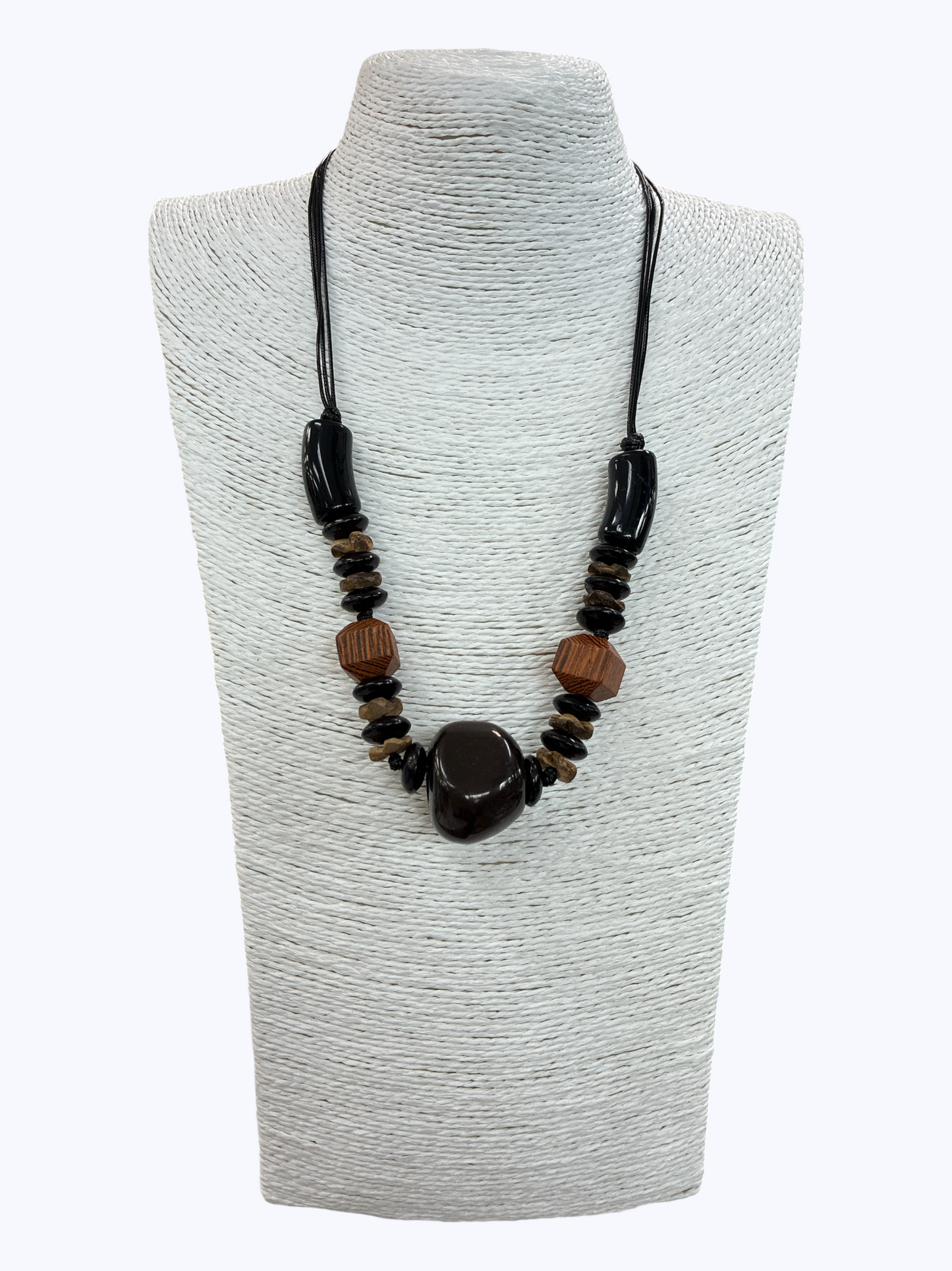 Black statement bead necklace with glossy centerpiece, wooden accent beads, and layered black cord for a modern earthy boutique style.
