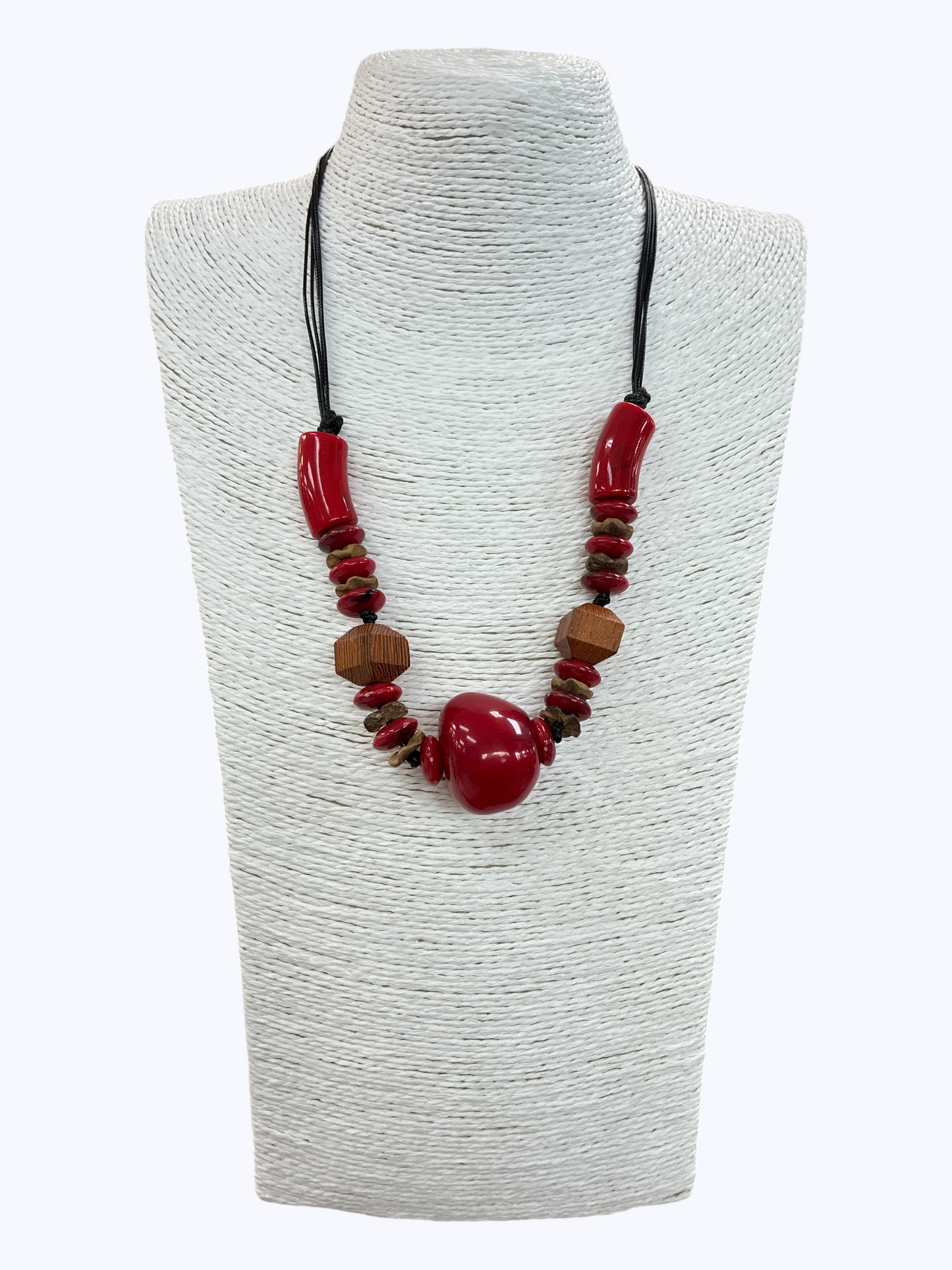 Red statement bead necklace with chunky glossy pendant, wooden accent beads, and black cord for a bold boutique-inspired look.