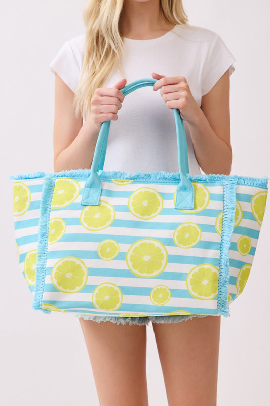 Person holding a colorful tote bag with lemon pattern