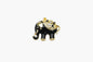 Black elephant pendant with gold accents and gemstones on a white background