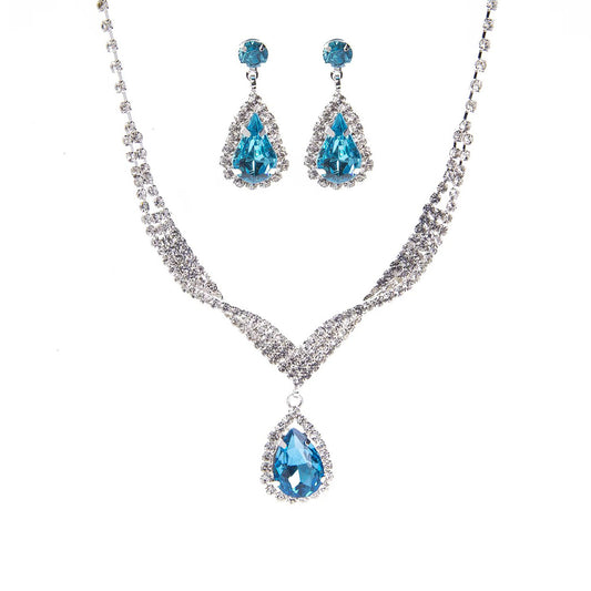 Jewelry set with blue teardrop-shaped stones on a white background