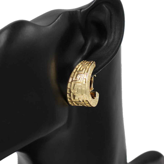 Greek key huggie earrings featuring engraved geometric detailing and a bold curved silhouette.